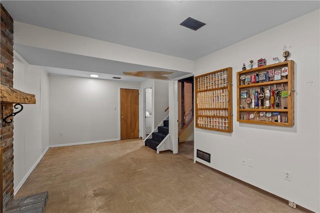 unfurnished living room with baseboards and stairs