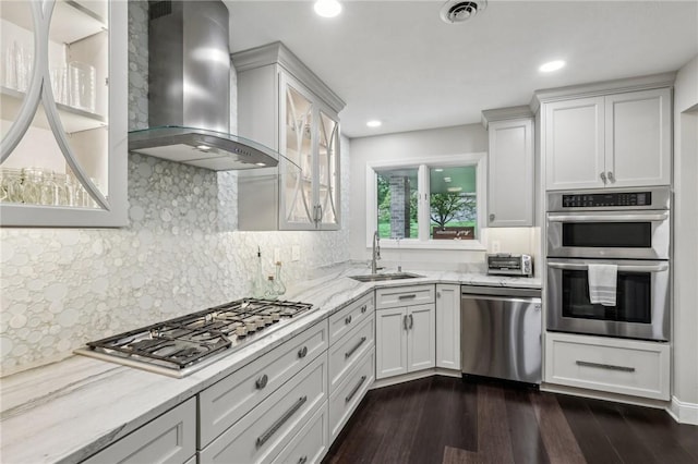 1231 Nicklaus Way W, Deer, PA 15044 - kitchen with wall chimney exhaust hood, appliances with stainless steel finishes, a sink, dark wood-style floors, and light stone counters