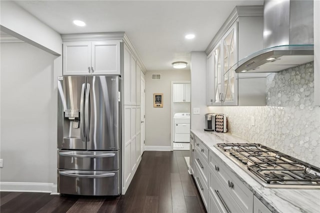 1231 Nicklaus Way W, Deer, PA 15044 - kitchen with appliances with stainless steel finishes, wall chimney exhaust hood, washer / dryer, baseboards, and backsplash