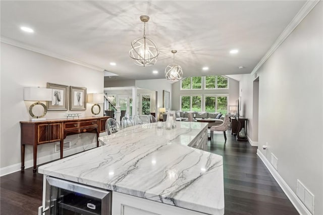 1231 Nicklaus Way W, Deer, PA 15044 - kitchen with open floor plan, a chandelier, wine cooler, crown molding, and white cabinets