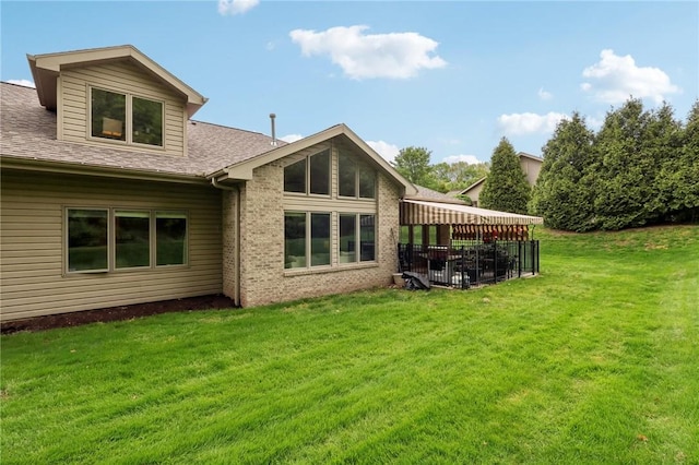 1231 Nicklaus Way W, Deer, PA 15044 - rear view of property featuring a lawn, brick siding, a shingled roof, and a patio