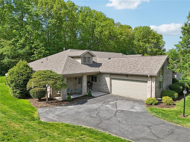 1231 Nicklaus Way W, Deer, PA 15044 - view of front facade featuring driveway, an attached garage, a shingled roof, brick siding, and a front yard