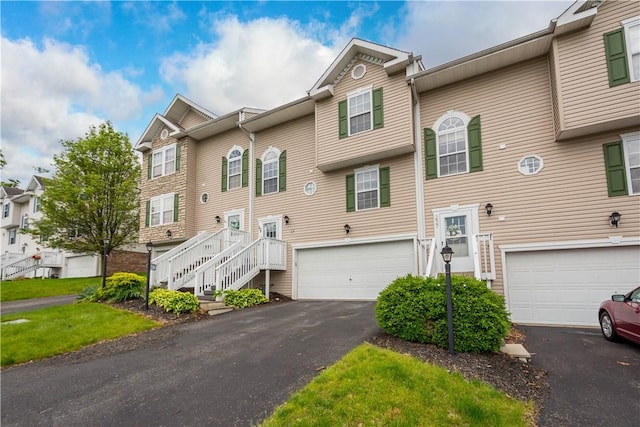 239 Mountain Dr, Carnegie, PA 15106 - view of property featuring a garage, driveway, and stairway