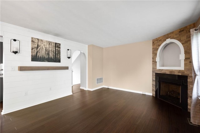 239 Mountain Dr, Carnegie, PA 15106 - unfurnished living room featuring wood finished floors, a large fireplace, baseboards, and arched walkways