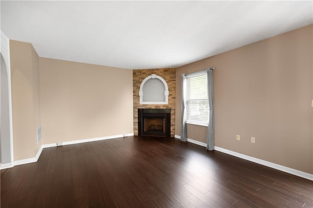 239 Mountain Dr, Carnegie, PA 15106 - unfurnished living room featuring a large fireplace, baseboards, and dark wood-type flooring