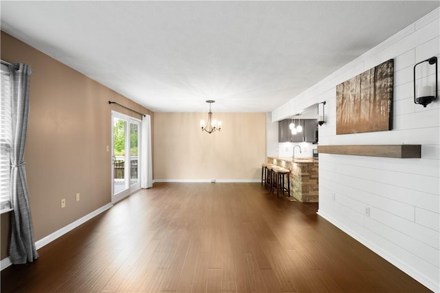 239 Mountain Dr, Carnegie, PA 15106 - unfurnished living room with a chandelier, dark wood finished floors, a sink, and baseboards