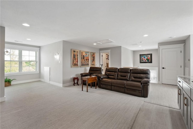 living room featuring light colored carpet, attic access, baseboards, and recessed lighting