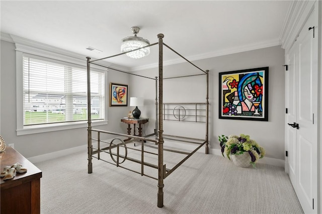 bedroom with carpet flooring, ornamental molding, baseboards, and a closet