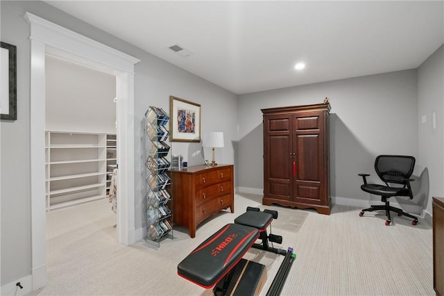 exercise area featuring carpet, baseboards, and recessed lighting