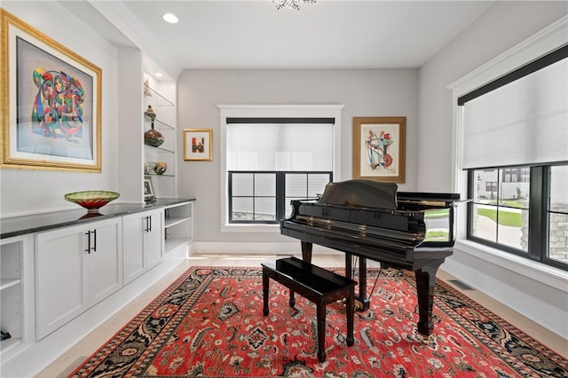 living area with baseboards and recessed lighting
