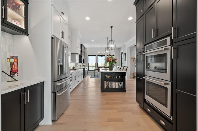 kitchen with appliances with stainless steel finishes, white cabinets, a chandelier, open shelves, and recessed lighting