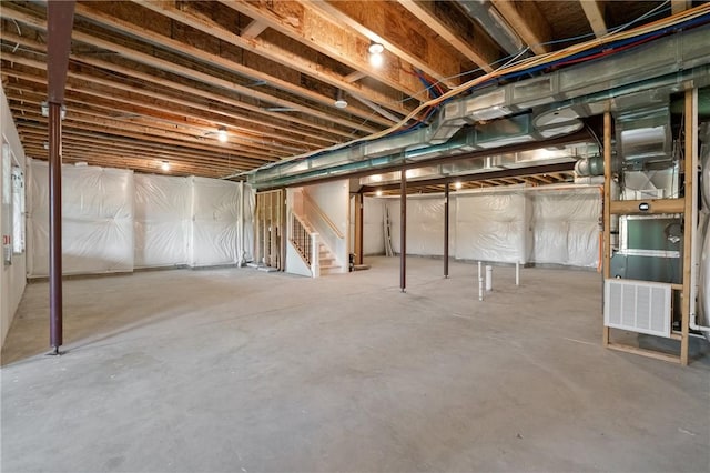 unfinished basement featuring stairway