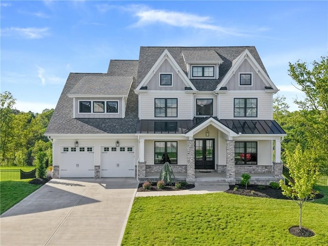 view of front of property featuring a porch, a standing seam roof, concrete driveway, stone siding, and board and batten siding
