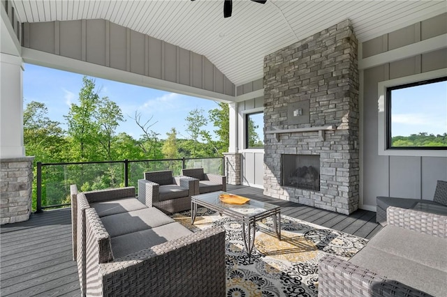 wooden terrace featuring an outdoor living space with a fireplace