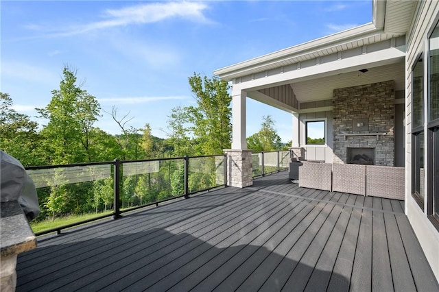 wooden terrace featuring an outdoor living space with a fireplace