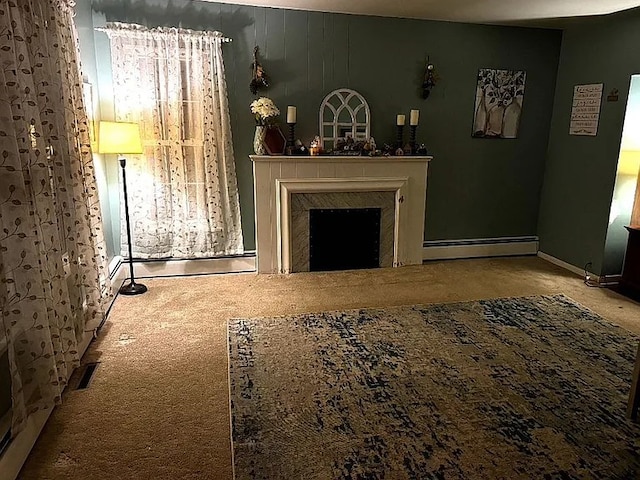 carpeted living area with a baseboard radiator and a fireplace
