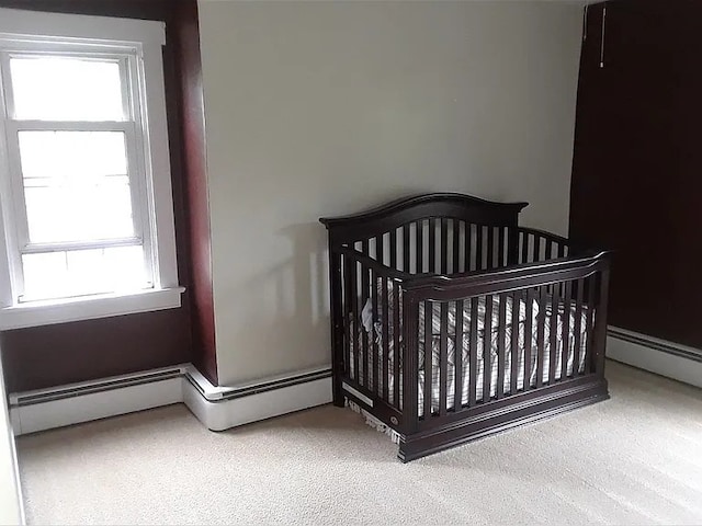 carpeted bedroom with baseboard heating