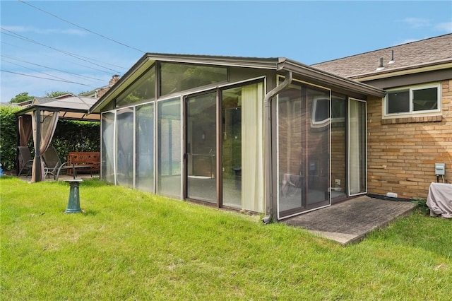 4782 Barone Dr, Whitehall, PA 15227 - rear view of house with a sunroom, a gazebo, a lawn, and brick siding