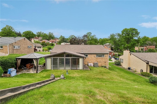 4782 Barone Dr, Whitehall, PA 15227 - rear view of property featuring a gazebo, a sunroom, a yard, and brick siding
