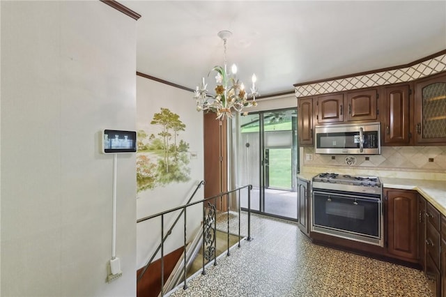 4782 Barone Dr, Whitehall, PA 15227 - kitchen featuring stainless steel microwave, range with gas cooktop, a chandelier, light countertops, and tasteful backsplash