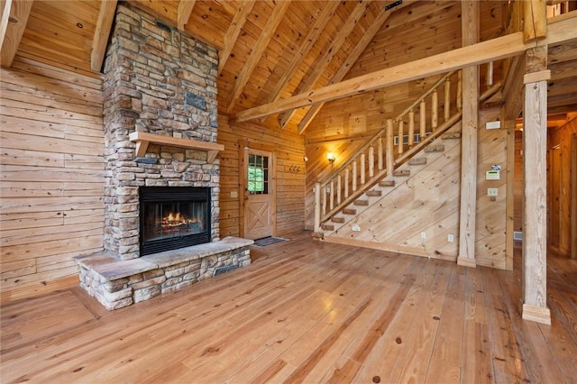 365 Hemlock Bnd, Emlenton, PA 16373 - unfurnished living room featuring wood walls, hardwood / wood-style flooring, a fireplace, wood ceiling with exposed beams, and high vaulted ceiling
