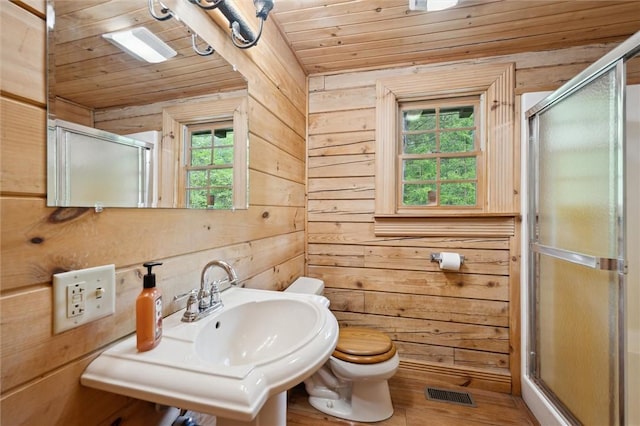 365 Hemlock Bnd, Emlenton, PA 16373 - full bath featuring wooden ceiling, a shower stall, wooden walls, toilet, and a sink