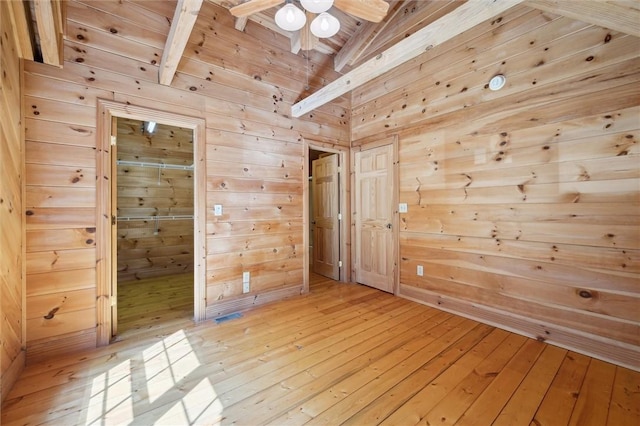 365 Hemlock Bnd, Emlenton, PA 16373 - empty room with wood walls, light wood-style flooring, a ceiling fan, and wood ceiling with exposed beams