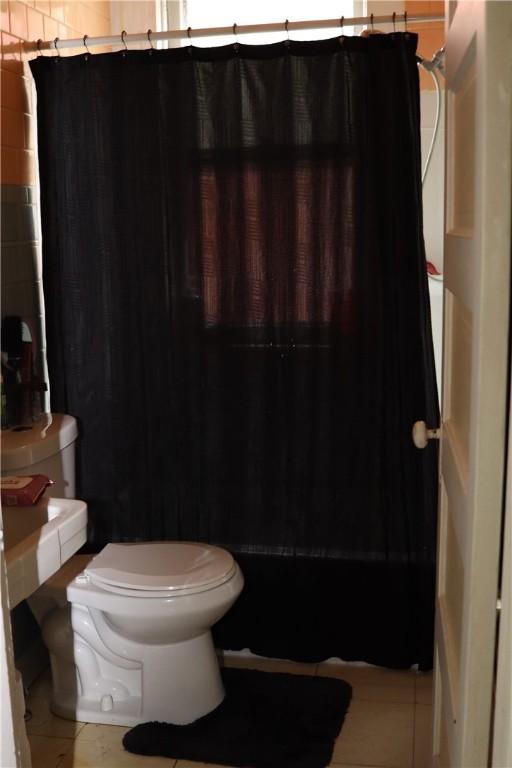518 Middle Ave, Wilmerding, PA 15148 - bathroom with toilet, tile patterned flooring, and a shower with shower curtain