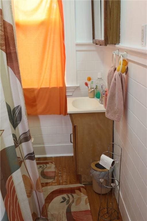 518 Middle Ave, Wilmerding, PA 15148 - full bathroom featuring vanity, wood finished floors, tile walls, and a shower with curtain