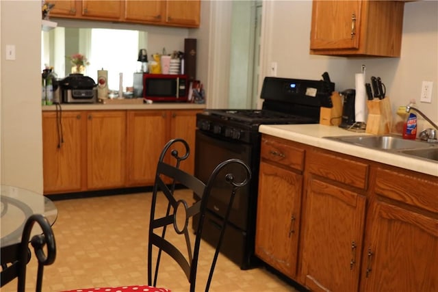 518 Middle Ave, Wilmerding, PA 15148 - kitchen with black gas range oven, light floors, brown cabinets, and light countertops