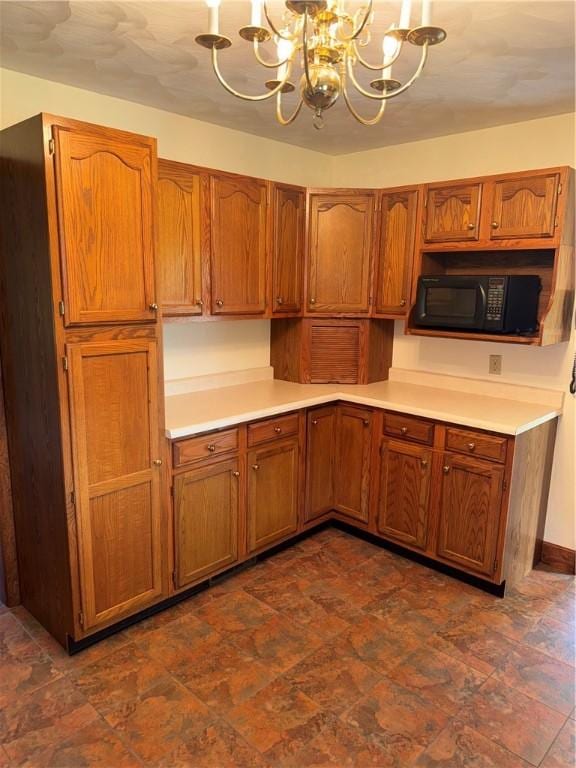 18 Finnin Rd, Allegheny Twp Wml, PA 15068 - kitchen with black microwave, a chandelier, brown cabinets, light countertops, and hanging light fixtures
