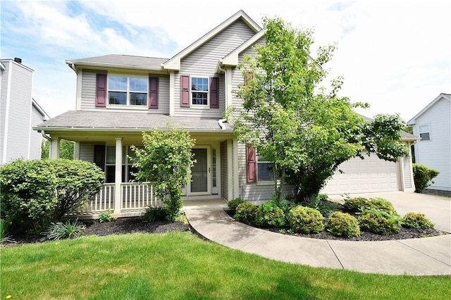 view of front facade featuring a porch, driveway, a front lawn, and a garage