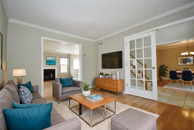 6755 Mars Crider Rd, Seven Fields Boro, PA 16046 - living area featuring wood finished floors, ornamental molding, a chandelier, a fireplace, and baseboards