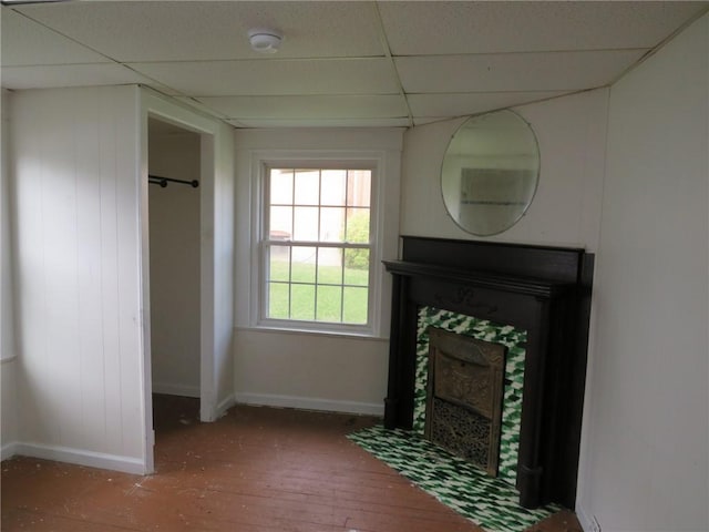 802 Howard St, Monongahela, PA 15063 - unfurnished living room with a paneled ceiling, a tile fireplace, baseboards, and wood-type flooring