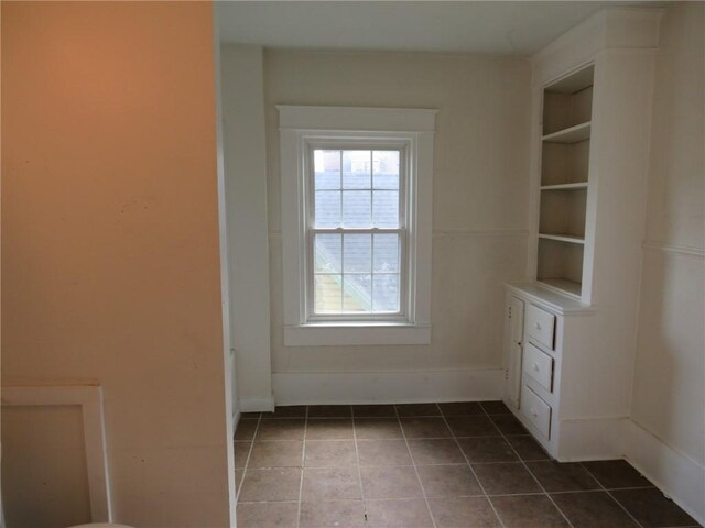 802 Howard St, Monongahela, PA 15063 - unfurnished dining area featuring tile patterned flooring, built in shelves, and baseboards