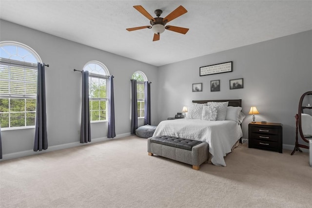 bedroom featuring carpet floors, multiple windows, and baseboards