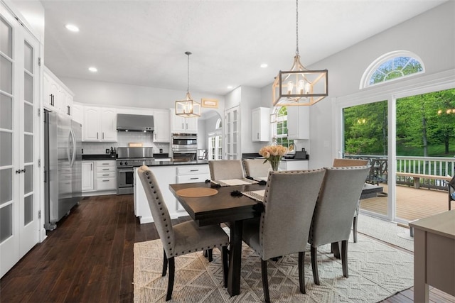 dining space with a chandelier, dark wood finished floors, and recessed lighting