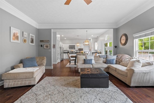 living area featuring crown molding, dark wood finished floors, a ceiling fan, baseboards, and recessed lighting