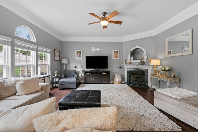 living room with ceiling fan, ornamental molding, dark wood-style floors, and a premium fireplace