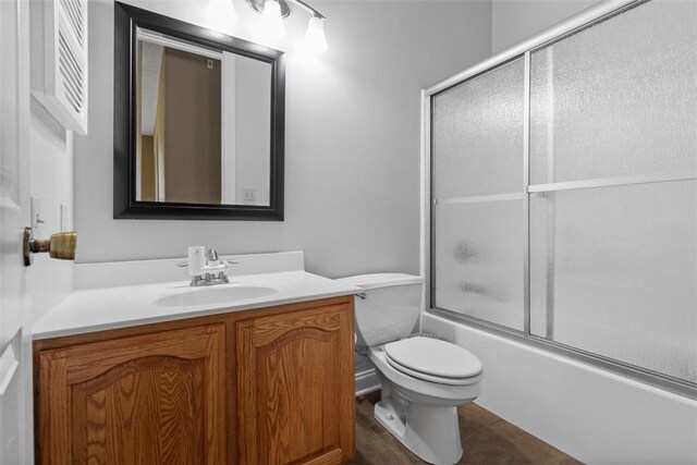 full bath with vanity, toilet, enclosed tub / shower combo, and tile patterned flooring