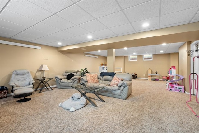 carpeted living area with a paneled ceiling, baseboards, and recessed lighting