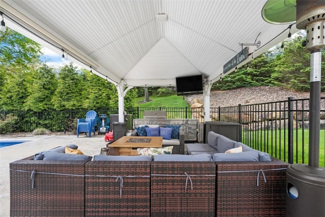 view of patio with an outdoor hangout area, a fenced backyard, area for grilling, and a gazebo