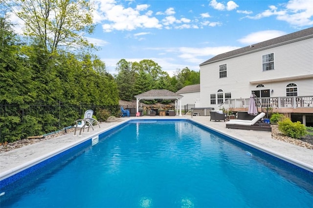 view of swimming pool featuring a gazebo, a fenced backyard, a deck, and a patio area