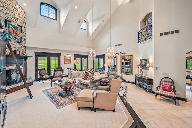 living room featuring a high ceiling, a chandelier, a stone fireplace, baseboards, and recessed lighting