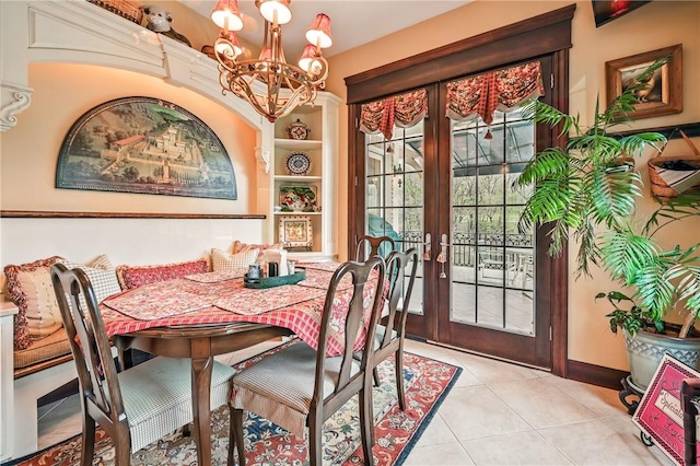 dining room featuring french doors, a chandelier, light tile patterned flooring, and baseboards