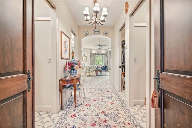 foyer featuring a chandelier and baseboards