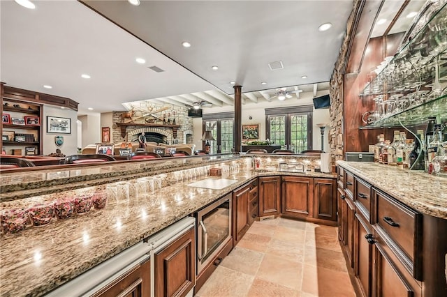 bar featuring ceiling fan, a fireplace, recessed lighting, and stainless steel microwave