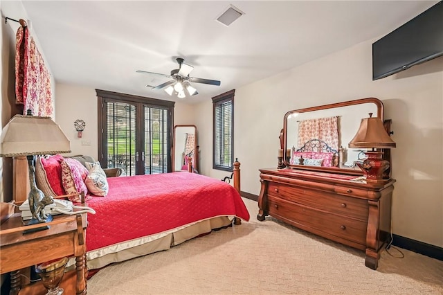 bedroom featuring multiple windows, baseboards, and access to exterior