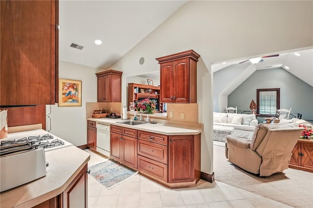 kitchen with dishwasher, light countertops, open floor plan, a sink, and recessed lighting
