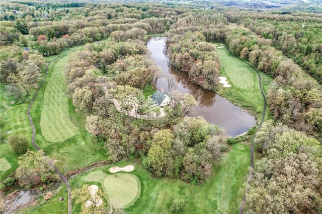 aerial overview of property's location with a large body of water, a golf club, and a heavily wooded area
